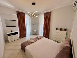 a bedroom with a bed with two towels on it at Salt & Soul downtown apartment in Mesolongion