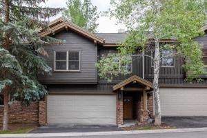 a black house with a garage at Scenic Location, Sleeps 8, 5 min to Base & Bike Access, Private Hot Tub, Walk to restaurants! in Park City