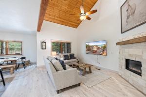 a living room with a couch and a fireplace at Scenic Location, Sleeps 8, 5 min to Base & Bike Access, Private Hot Tub, Walk to restaurants! in Park City