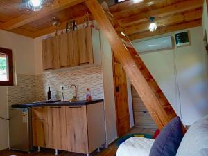 a kitchen with a staircase in a tiny house at Kutak za dušu in Mojkovac +8 photos