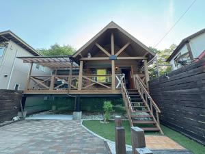a house with a staircase leading up to it at 裏に川がある貸切別荘 in Takashima