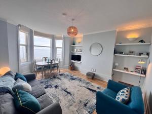 a living room with a couch and a table at Newly Refurbished - Margate Sunset Retreat in Margate