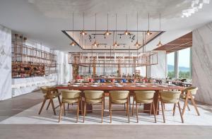 a dining room with a large table and chairs at voco Ma Belle Danang by IHG in Da Nang
