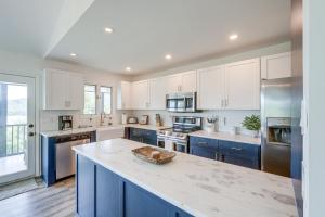 a kitchen with white cabinets and a blue island at Less Than 1 Mi to Lake Chatuge Home with Mtn and Water Views! in Young Harris