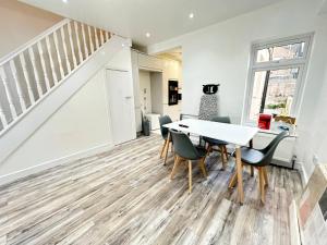 a dining room with a table and chairs and a staircase at Room in Portsmouth in Portsmouth