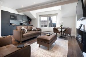 a living room with a couch and a table at Lake Road Apartments in Bowness-on-Windermere