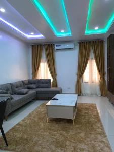 a living room with a couch and a table at Spacious Penthouse 1 Apartment in Lagos