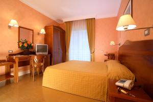 Postel nebo postele na pokoji v ubytování Hotel Conchiglia d'Oro