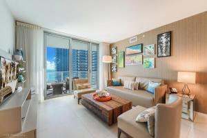 a living room with a couch and a table at LYFE Resort Ocean View Penthouse in Hollywood