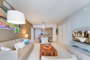 a living room with a couch and a table at LYFE Resort Ocean View Penthouse in Hollywood +15 photos