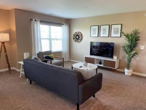 a living room with a couch and a tv at Retreat At The Charles Top Floor Gated Parking in Dublin