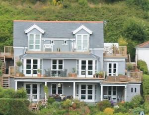 a large white house on top of a hill at Compass Rose in Dartmouth