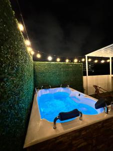 a jacuzzi tub on a patio at night at Muguet House Granada in Cali