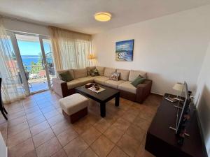a living room with a couch and a table at Apartment in Dramalj 54763 in Dramalj
