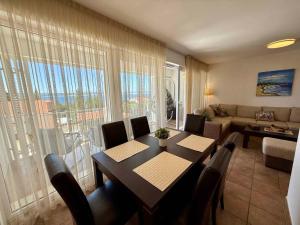 a living room with a table and chairs and a couch at Apartment in Dramalj 54763 in Dramalj