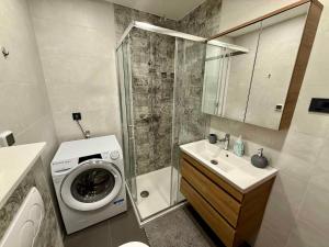 a bathroom with a washing machine and a washer at Apartment in Dramalj 54763 in Dramalj +17 photos