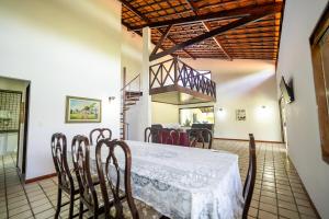 a dining room with a white table and chairs at Chácara paraíso da Suzy in Recife