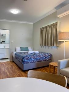 a bedroom with a bed and a living room at Bowen Holiday Park in Bowen +39 photos