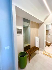 a bathroom with a mirror and a green stool at Santorini Village, Drymades, Dhermi in Dhërmi