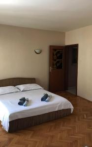 a bedroom with a large white bed with towels on it at Apartments by the sea Vis - 1170 in Vis