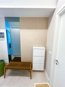 a room with a wooden bench in a room at Santorini Village, Drymades, Dhermi in Dhërmi