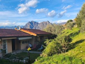 a house with a view of the mountains at L' Oliva Nera in Monte Isola