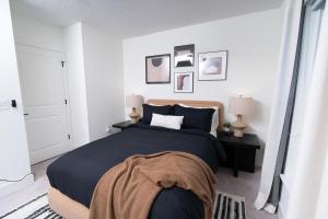 a bedroom with a large bed and two lamps at 3BR Chic Ybor City Tampa Firepit Bikes in Tampa