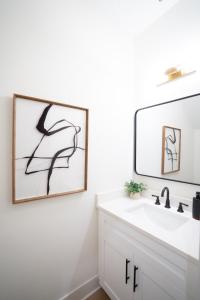 a bathroom with a sink and a mirror at 3BR Chic Ybor City Tampa Firepit Bikes in Tampa