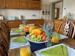 a table with a plate of fruit on it at Alpine Retreat - Lake Bled in Bled