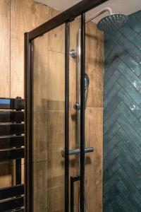 a shower with a glass door in a bathroom at 4BD Townhouse - Paddington! in London +37 photos
