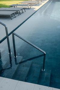 a pool of water with a metal railing in it at Sierra Mar in Isla Mujeres