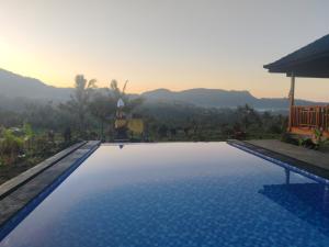 a swimming pool with a view of the mountains at Bukit Luah Sidemen in Sidemen