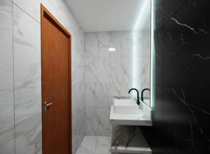 a bathroom with a sink and a mirror at Apartamento em Belém in Belém