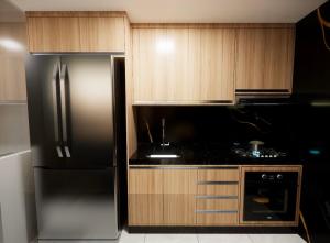 a kitchen with a stainless steel refrigerator and wooden cabinets at Apartamento em Belém in Belém +14 photos