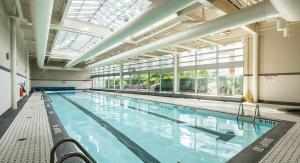 a large indoor swimming pool with a large window at Luxury 2BR Designer Apartment - Prime Downtown Location! in Vancouver