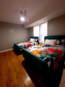 a bedroom with two beds and a window at Beautiful 4 bedroom 2 bathroom apartment near everything in Chicago