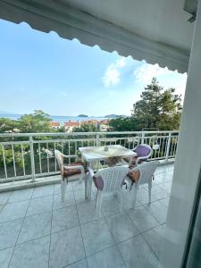 a patio with a table and chairs on a balcony at Dreams in Kavala +7 photos