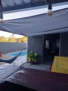 a patio with a hammock and a swimming pool at Recanto Eucaliptos in Araçoiaba da Serra