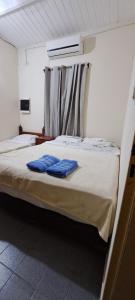 a bedroom with two blue pillows on a bed at Casa familiar cómoda in Santiago del Estero