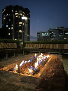 a fire pit in the middle of a city at night at Opulent Heights- Westpoint Sandton in Johannesburg