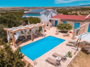 an image of a villa with a swimming pool at Secluded house with a swimming pool Kosljun, Pag - 22238 in Pag