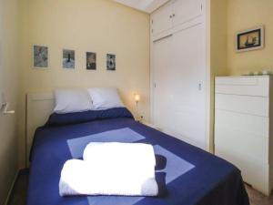 a bedroom with a bed with a blue blanket at Holiday home in Cabo de Palos with views in Cabo de Palos +13 photos