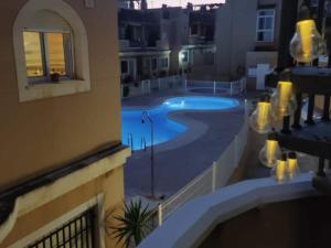 a view of a swimming pool from a balcony of a building at Inviting holiday home with pool in Palomares