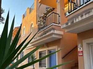 an apartment building with balconies and a plant at Inviting holiday home with pool in Palomares