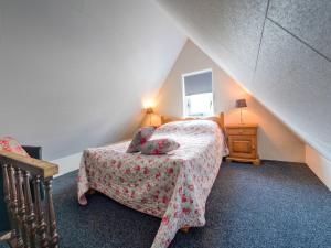 a bedroom with a bed and a table and a window at Holiday home in Elim for family in Elim