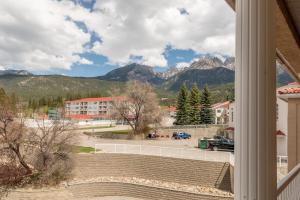 a view from a window of a parking lot with mountains at Cozy Fairmont Hot Springs 1br Condo in Fairmont Hot Springs