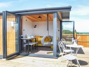 a glass extension of a house with a table and chairs at Sky Lark Lodge - Uk49904 in Appley Bridge