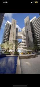 three tall buildings with a pool in front of them at Hotel Platinum - Landscape Luxo - in Fortaleza +37 photos