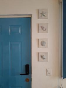 a room with a blue door and some pictures on the wall at "Le Petit Oasis" Pool, AC and Beach 1 minute away in La Peñita de Jaltemba +25 photos