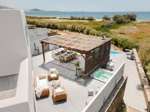 an aerial view of a house with a swimming pool and the ocean at Mikri Tranquilla - Beach, Seaview, Pool, Jacuzzi in Plaka